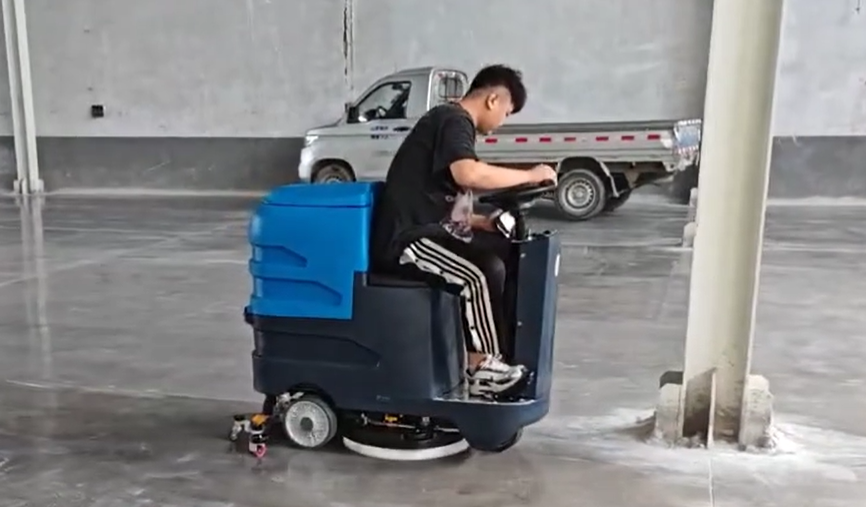 What equipment is used to clean the floor in the manufacturing plant workshop